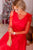 Matching party red dresses with pearls and feathers for mother and daughter